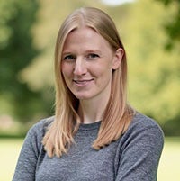woman smiling with her arms crossed