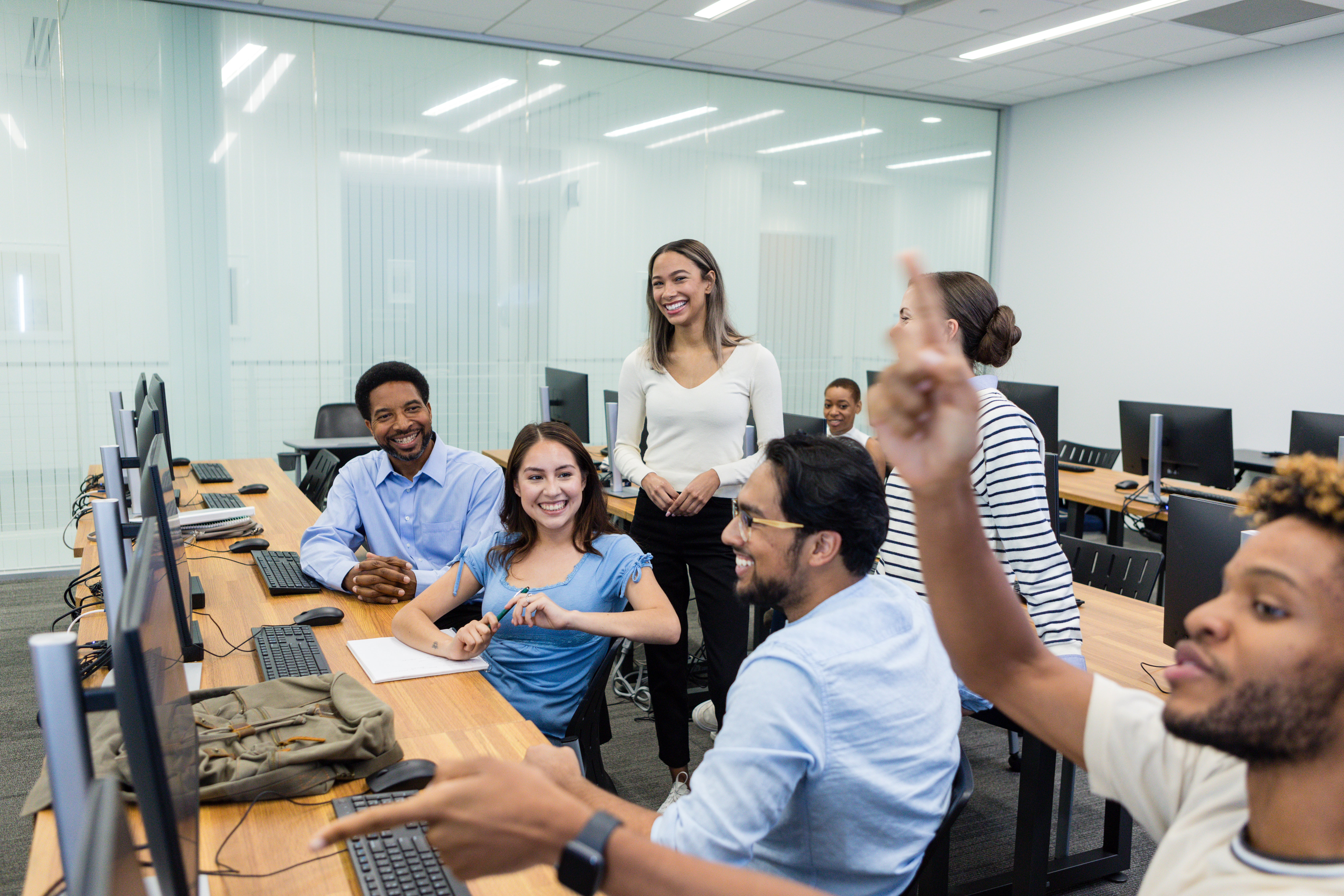 Young adult students actively participating in a tech class