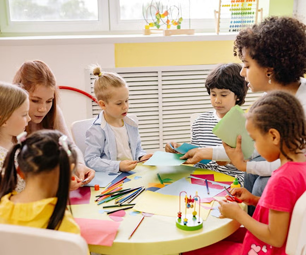 teacher with students doing crafts