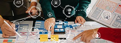 collaborative UX designers working at a table with website l