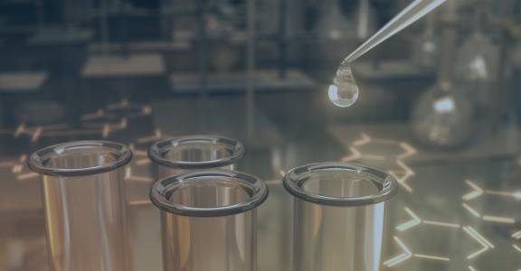 Dropper filling a test tube in a clinical test lab