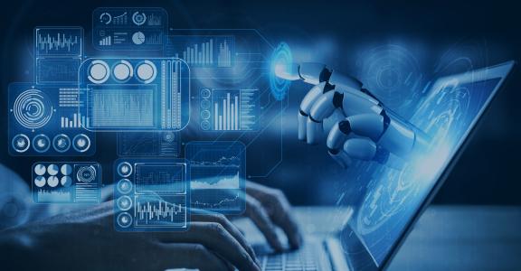 closeup of person typing on a laptop and a robot's hand coming out of the monitor