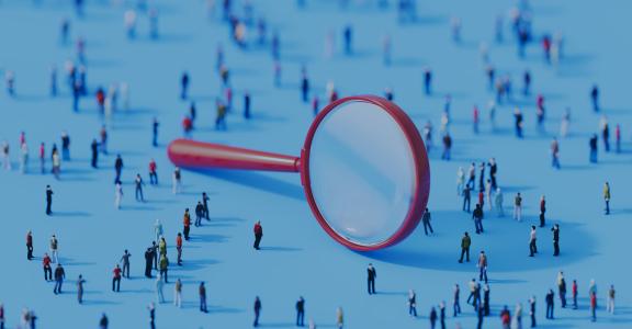 Human crowd surrounding a magnifier object on blue background