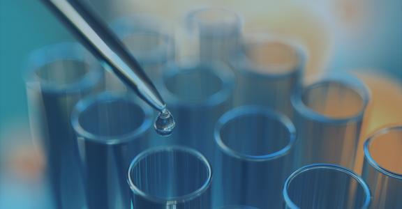 Close up of examining of test sample with test tubes
