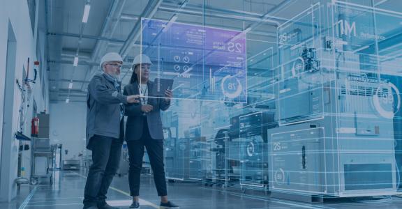 2 business people in hard hats looking at warehouse data on a projection