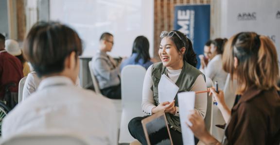 Team building, Asian workshop participants in small group discussion, brainstorming during workshop class