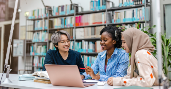Three multiethnic student studying in library