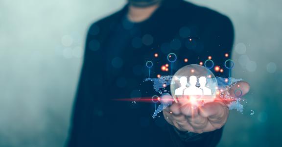 Man in suit holding glass globe with a network structure world map and business digital network technology