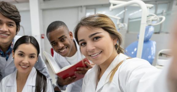 Group of young medical students taking a selfie in their whi