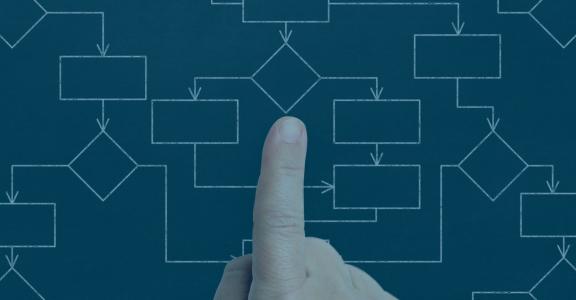 Finger pointing a black and white flow chart with different 