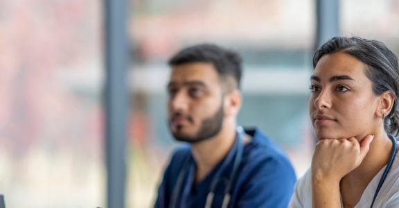 Two healthcare professionals in a classroom