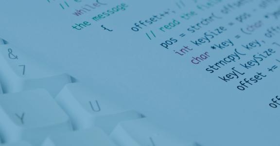 white keyboard and piece of paper with code