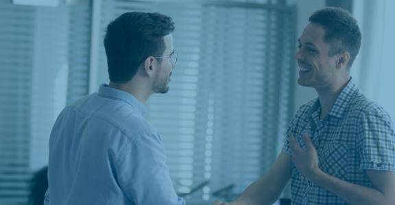 Two men talking and smiling