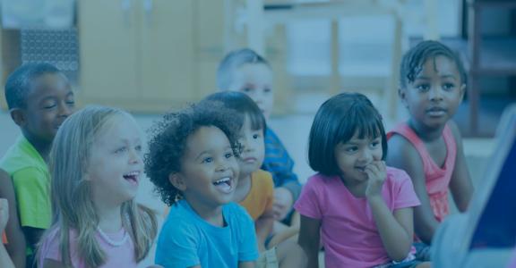 Teacher doing storytime with laughing kids