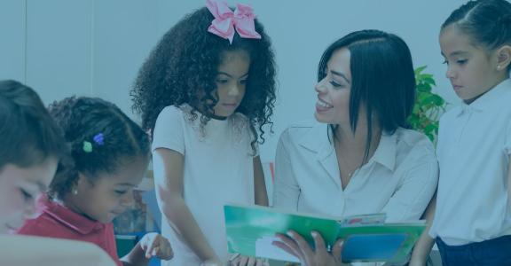 Teacher showing girls a book