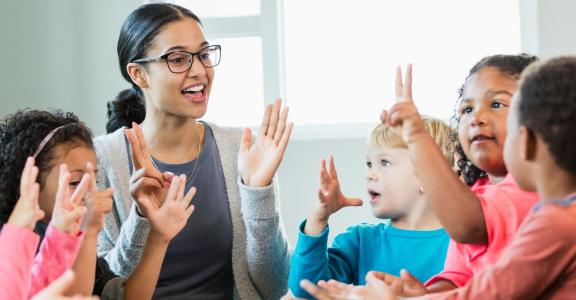 Latina woman teaching preschoolers