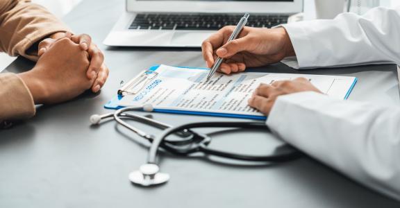 Doctor consulting with patient about medical diagnosis repor