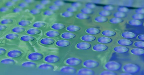 Tray of pcr/biological tests with a green and purple overlay