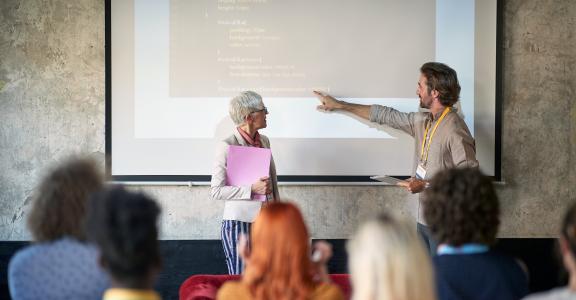 Employees at a presentation in a working atmosphere in the conference room.