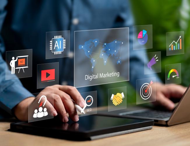 digital marketing icons overlay person using laptop