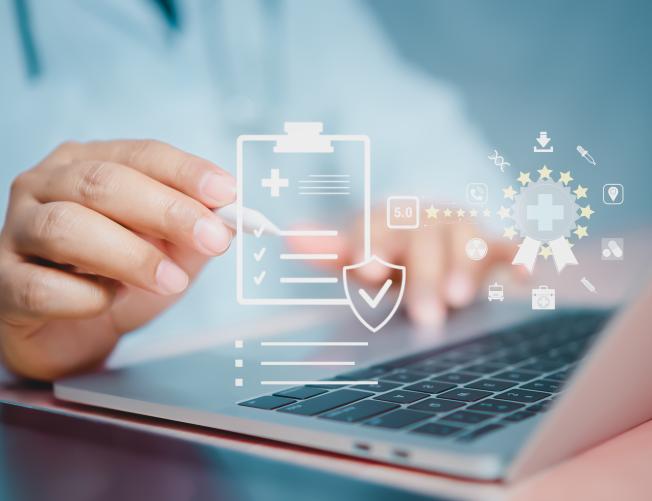 medical professional with digital pen and laptop with medical compliance diagram overlay