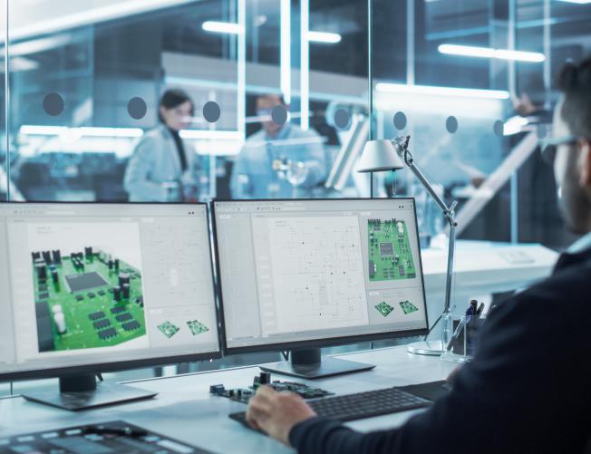 Man developing 3D Model of a Circuit Motherboard on Computer CAD Software