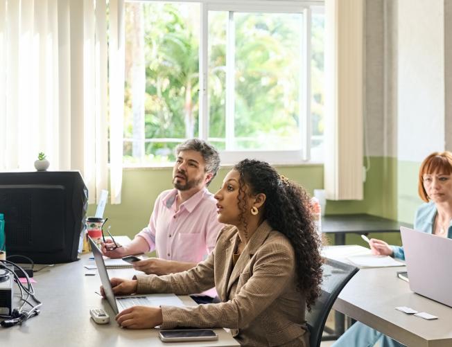 teacher helping students in a classroom