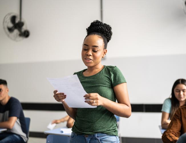 Teeange student reading aloud in the classroom