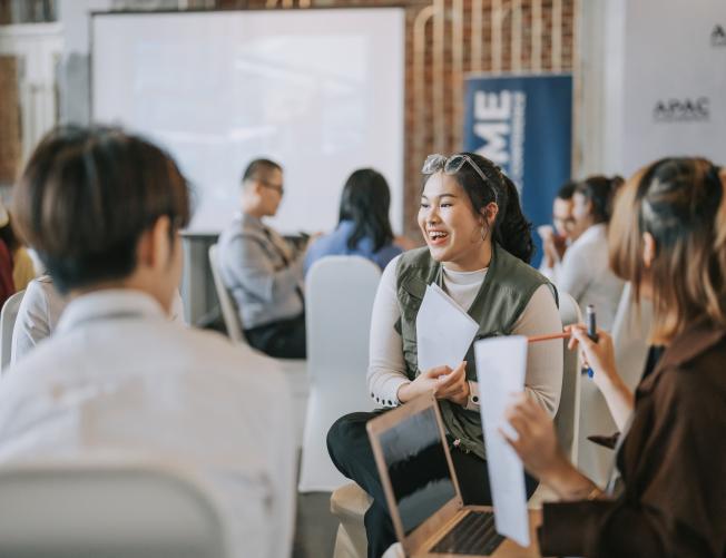 Team building, Asian workshop participants in small group discussion, brainstorming during workshop class