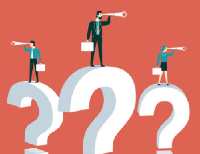 Business professionals standing on top of big question marks