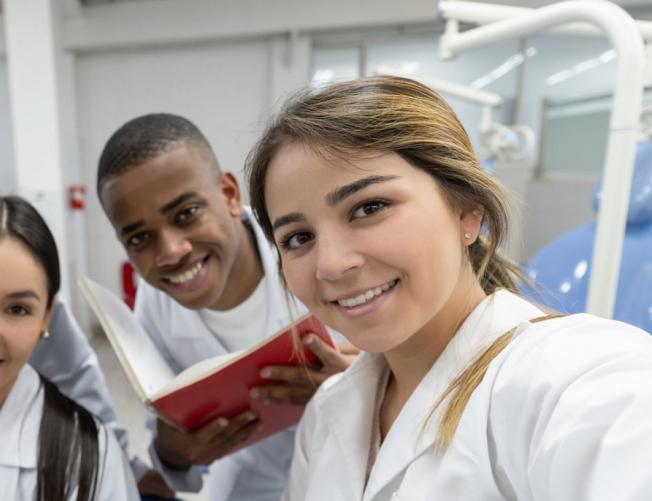 Group of young medical students taking a selfie in their whi