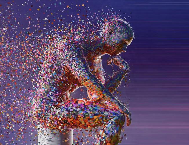 man sitting as particles of his body dissipate.