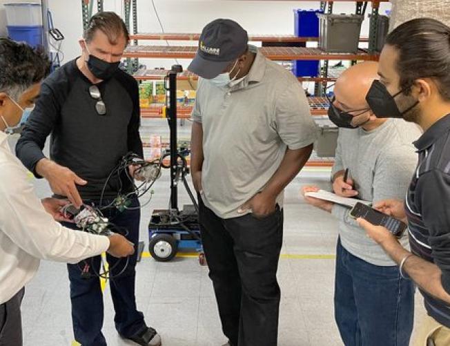 Students studying robotics technology in AI course