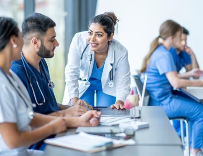 Premed Lecture Series: Students scrubs in a classroom