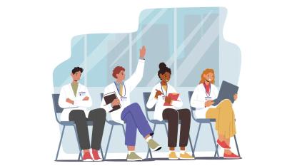 four young physicians sitting in chairs in a classroom