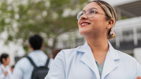 woman in lab coat outside. 