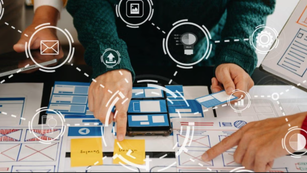 Group of hands working on different portions of table project. 