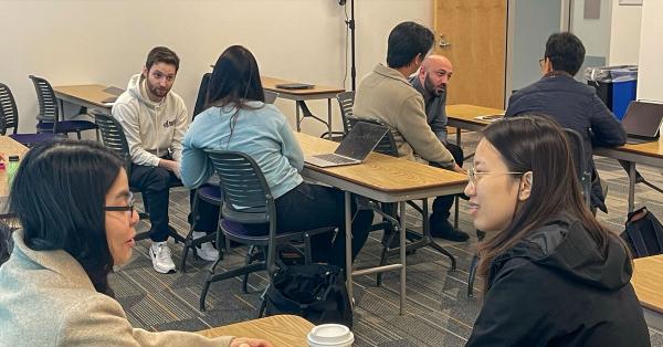 clusters of students talking together in classroom