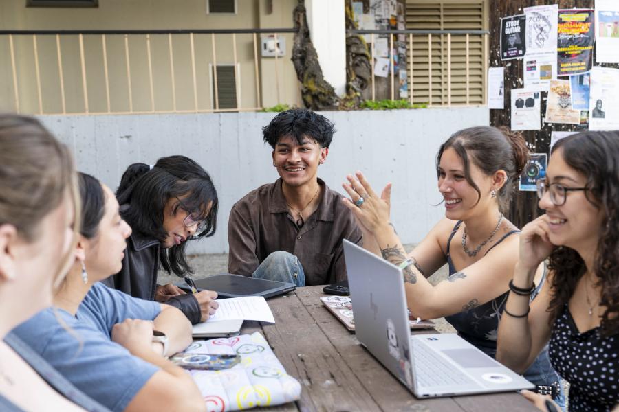 Group of students studying and discussing in outdoor setting